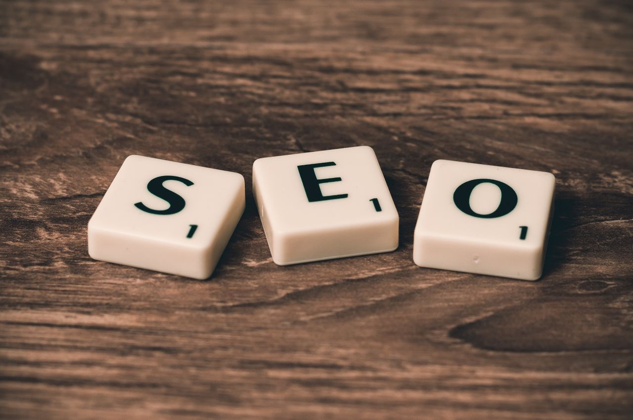 services-04 Scrabble tiles spelling SEO on a wooden surface. Ideal for digital marketing themes.